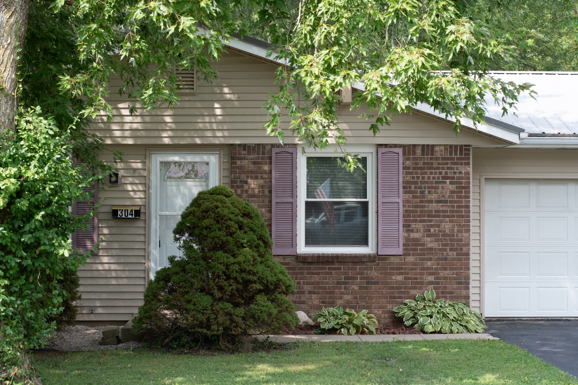 Close view of the front entry, brick facade and house number 304