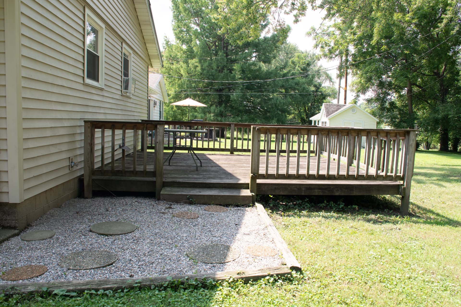 Wraparound wooden deck and patio photographed for a real estate listing