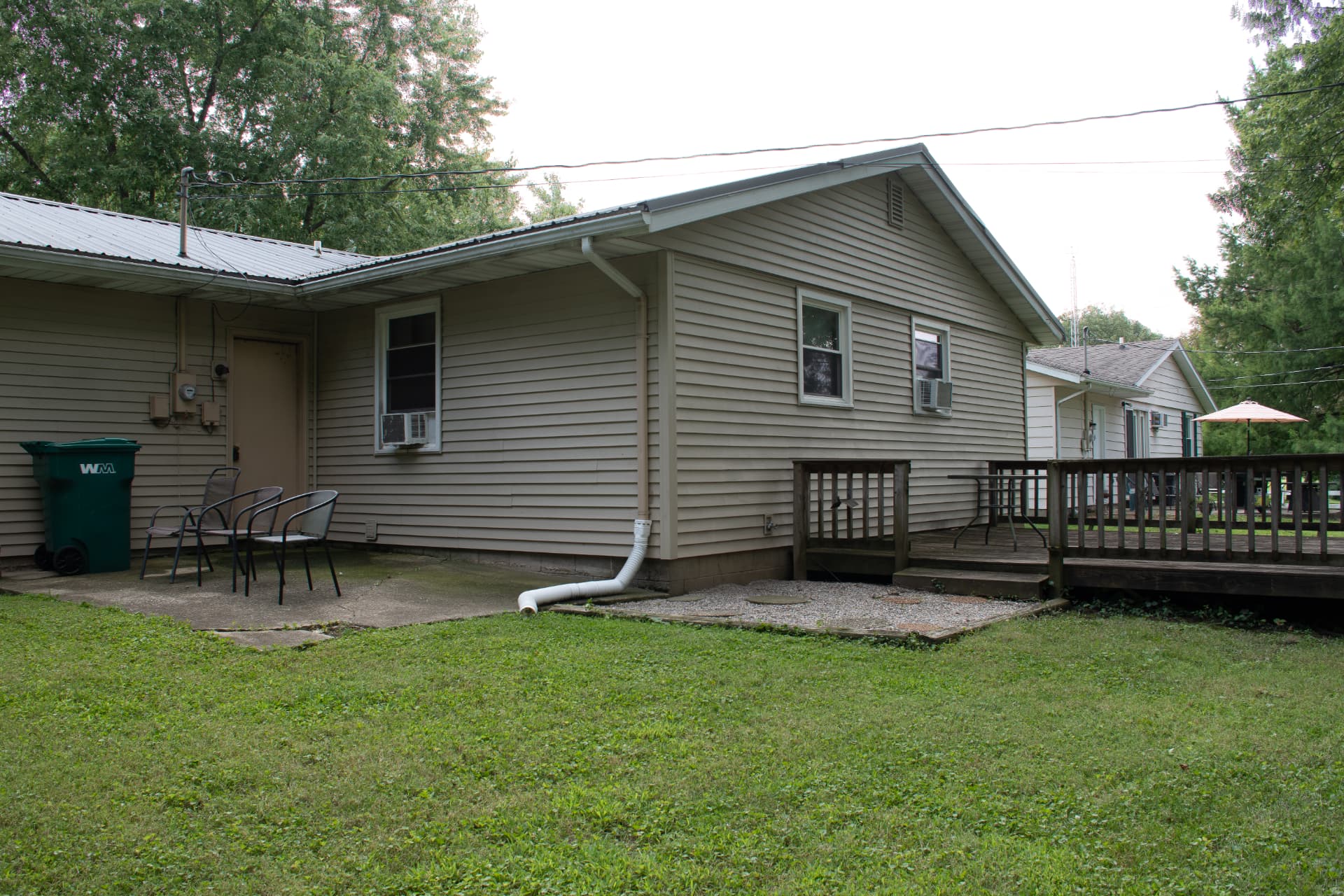 Angled rear exterior view showing patio, deck and side yard